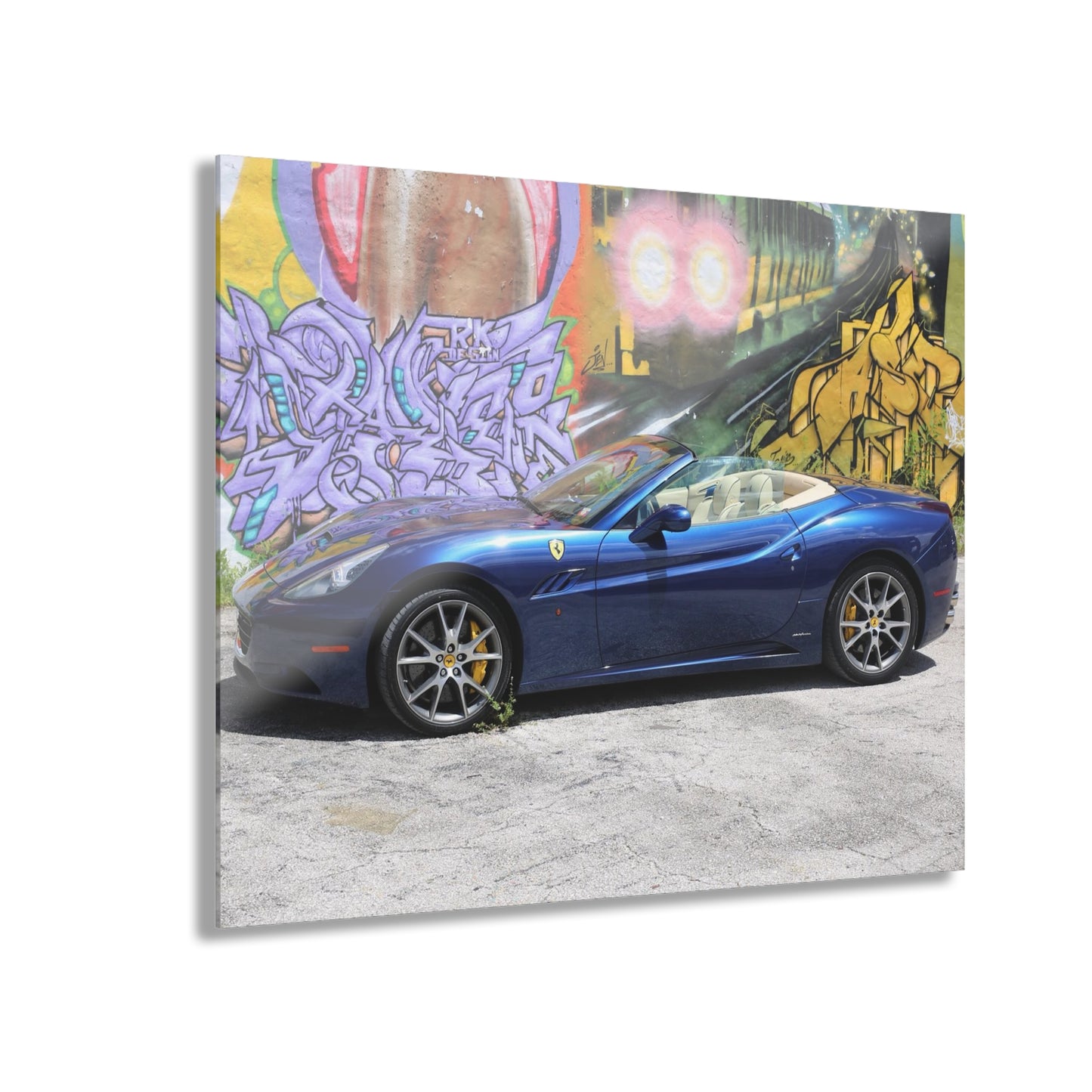 Ferrari California in deep ocean blue, captured against a vibrant urban graffiti mural.Modern Acrylic Print - Urban Car Art for Home Decor