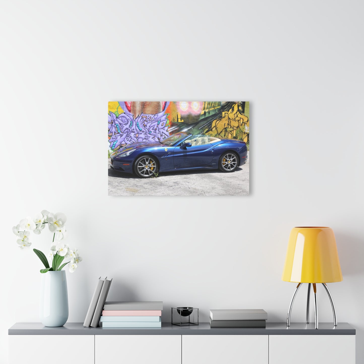 Ferrari California in deep ocean blue, captured against a vibrant urban graffiti mural.Modern Acrylic Print - Urban Car Art for Home Decor