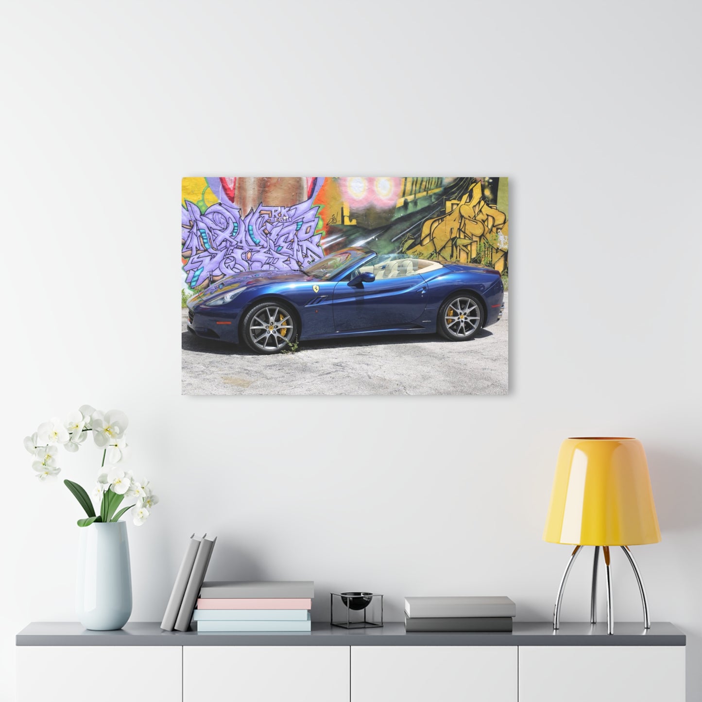 Ferrari California in deep ocean blue, captured against a vibrant urban graffiti mural.Modern Acrylic Print - Urban Car Art for Home Decor