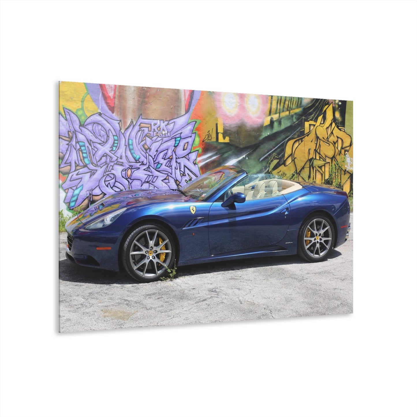 Ferrari California in deep ocean blue, captured against a vibrant urban graffiti mural.Modern Acrylic Print - Urban Car Art for Home Decor